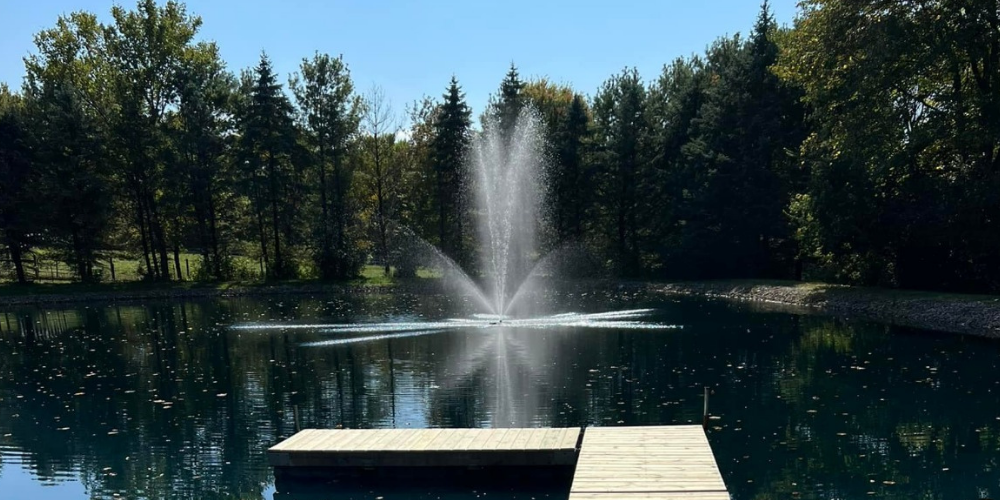 Uneven pond fountain spray pattern due to debris or mineral buildup clogging nozzle openings